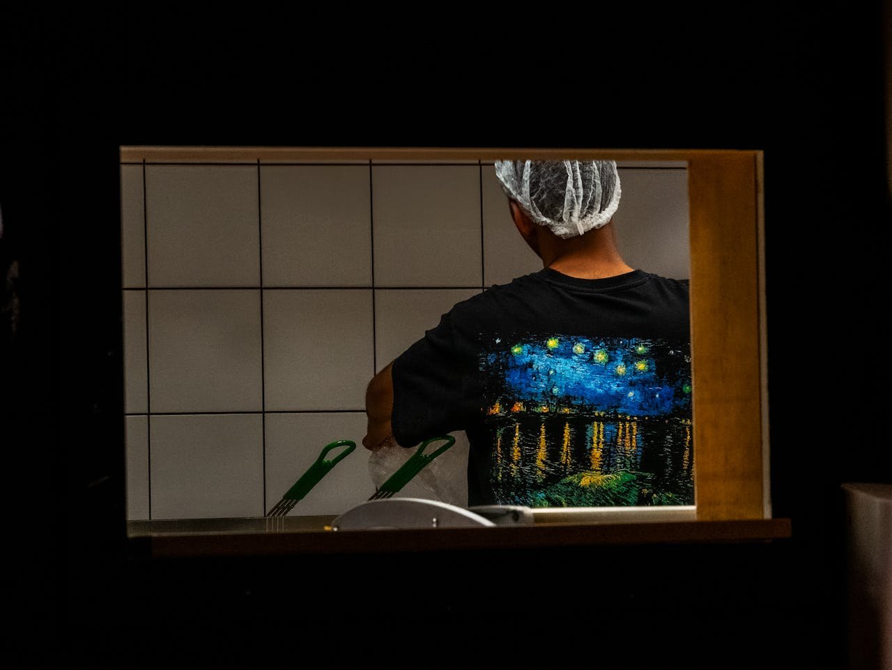 indoor-shot-of-chef-in-kitchen-through-window-33485661